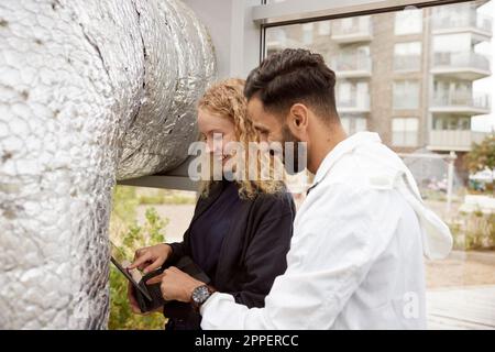 Man and woman using digital tablet Stock Photo