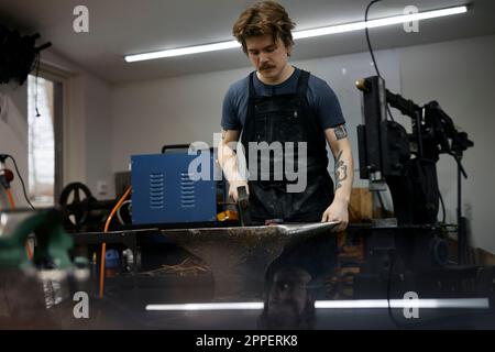 Blacksmith working in his workshop Stock Photo