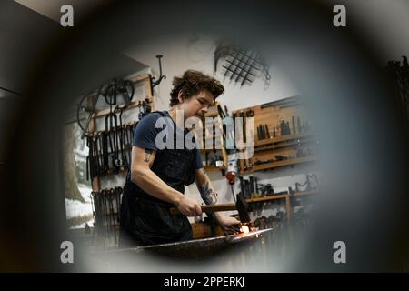 Blacksmith working in his workshop Stock Photo