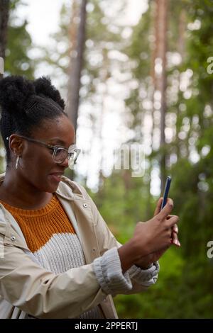Young woman taking photo with cell phone Stock Photo