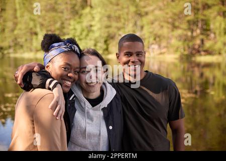 Smiling friends looking at camera Stock Photo