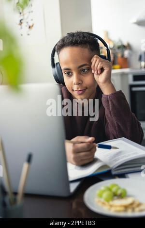 Boy doing homework at home Stock Photo
