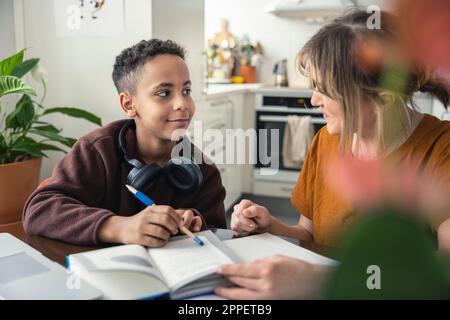 Mother helping son with homework Stock Photo