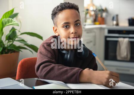 Boy doing homework at home Stock Photo