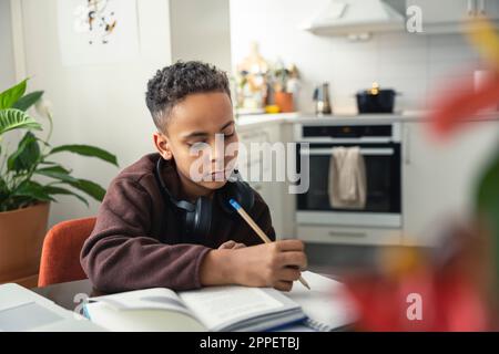 Boy doing homework at home Stock Photo