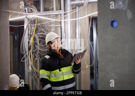 Female engineer using digital tablet at building site Stock Photo