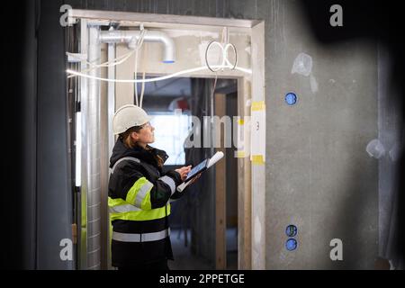 Female engineer using digital tablet at building site Stock Photo