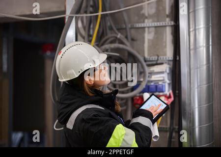 Female engineer using digital tablet at building site Stock Photo