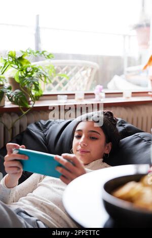 Girl playing on a bean bag Stock Photo - Alamy