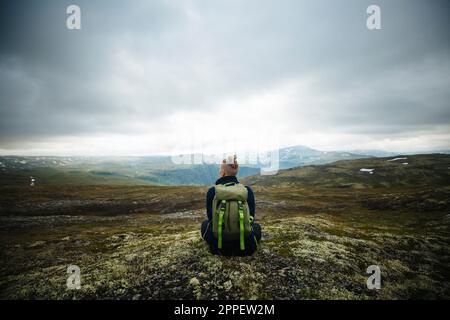 Rear view of hiker in mountains Stock Photo