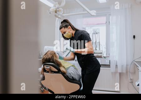 Female dentist with patient in dentist's office Stock Photo