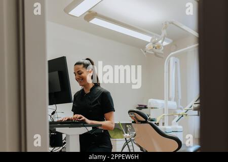 Female dentist using computer in office Stock Photo