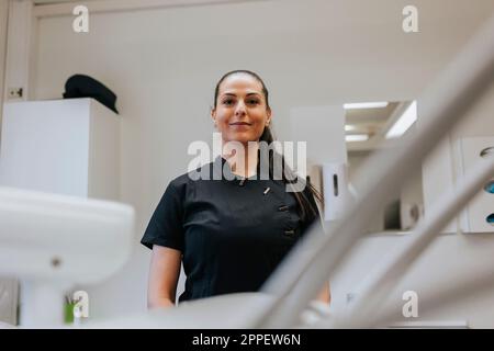 Female dentist standing in office Stock Photo