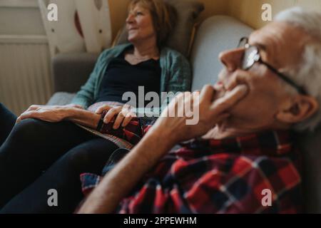 Senior couple relaxing on sofa Stock Photo