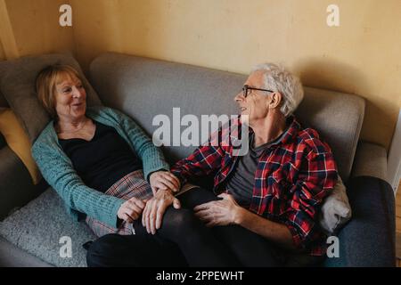 Senior couple relaxing on sofa Stock Photo