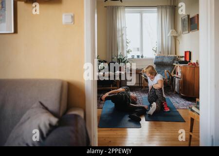 Senior couple doing yoga at home Stock Photo