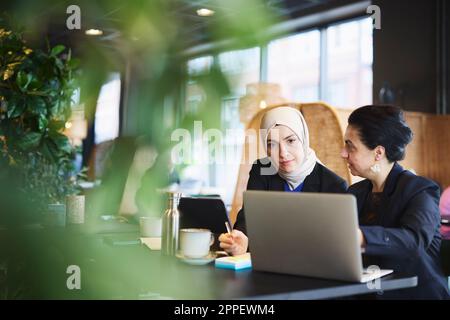 Businesswomen using digital tablet in cafe Stock Photo