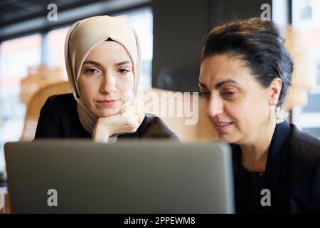 Businesswomen using digital tablet in cafe Stock Photo