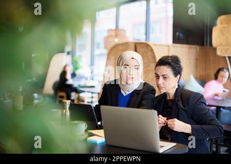 Businesswomen using digital tablet in cafe Stock Photo