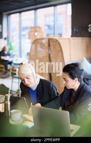 Businesswomen using digital tablet in cafe Stock Photo