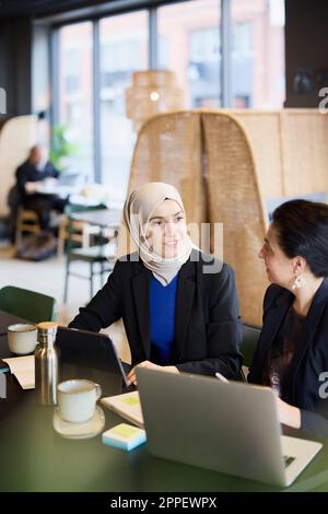 Businesswomen using digital tablet in cafe Stock Photo