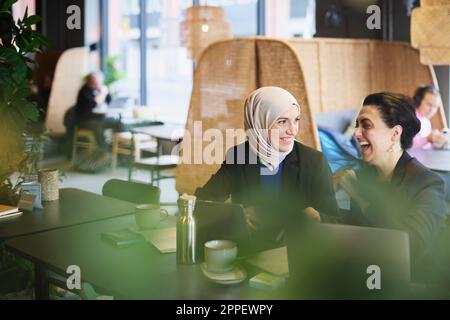 Businesswomen using digital tablet in cafe Stock Photo