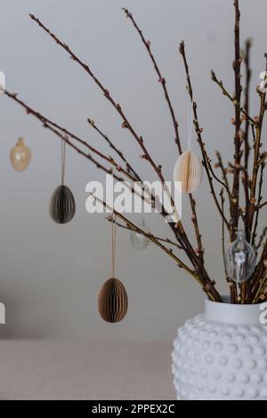 Twigs with paper Easter eggs hanging on them Stock Photo