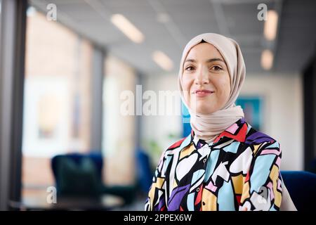 Portrait of smiling businesswoman in hijab Stock Photo
