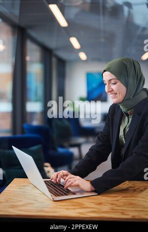 Woman in office using laptop Stock Photo