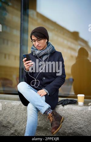 Smiling man using cell phone Stock Photo