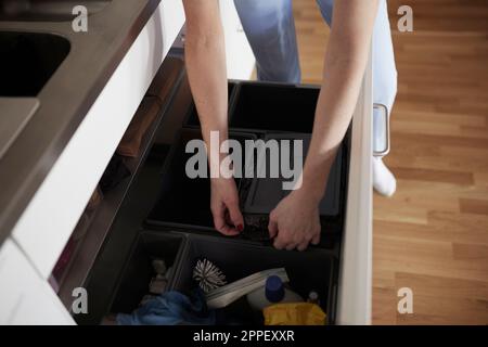 Woman's hands opening bin Stock Photo