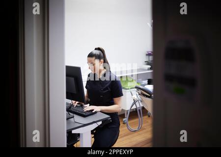 Female dentist using computer in office Stock Photo