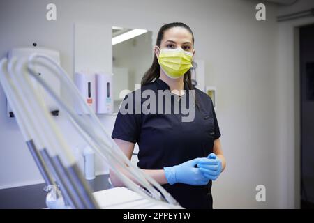 Female dentist standing in office Stock Photo