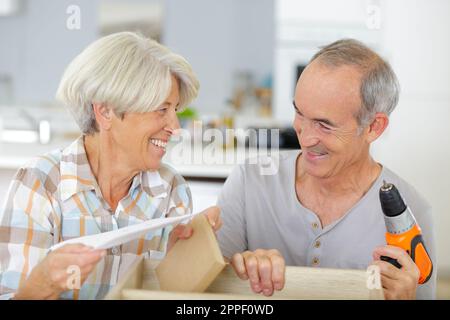 happy senior couple doing diy Stock Photo