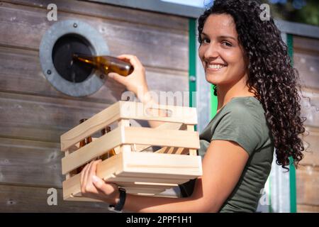 woman deposing of environmental recycling waste Stock Photo