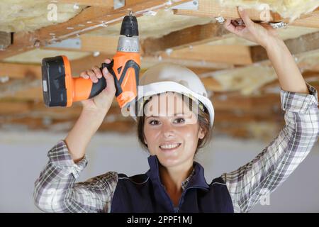 portrait of female builder using cordless drill Stock Photo