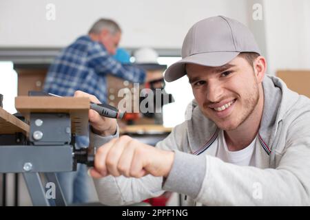 carpenter with apprentice in training period Stock Photo