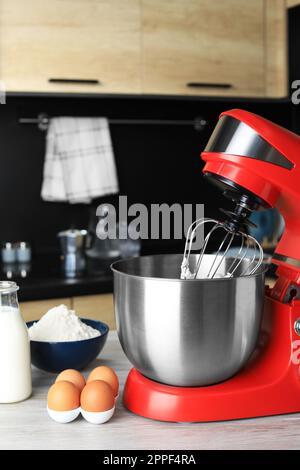 White kitchen machine and stand mixer on a wooden table in a bright design  apartment Stock Photo - Alamy