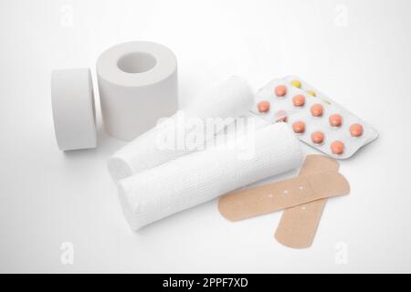 Medical bandage rolls, bandage, elastic , scotch tape, first aid supplies,  a white background. Stock Photo