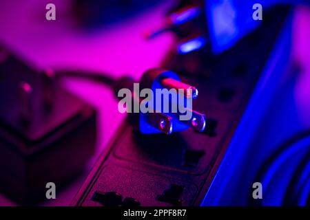 Close up 3-leg plug on electrical power strip. Stock Photo
