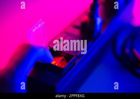 Close up a mans hand turn on the switch on power strip. Stock Photo