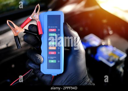 Checking a car battery level with car battery checker, car repairing concept Stock Photo