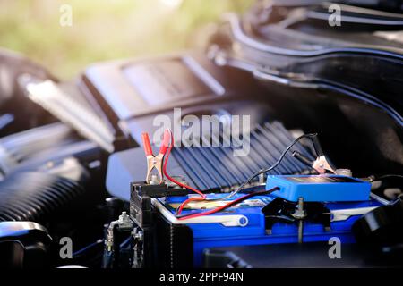 Checking a car battery level with car battery checker, car repairing concept Stock Photo