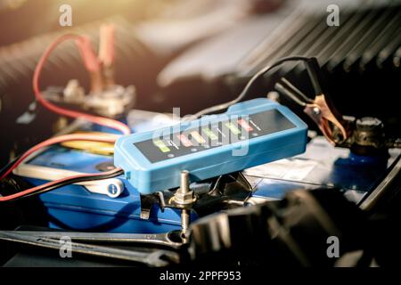 Checking a car battery level with car battery checker, car repairing concept Stock Photo