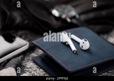 Pair of white wireless earbuds for smartphone. Relaxation concept. Stock Photo