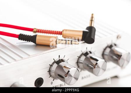 Close up red AUX(Auxiliary) cable on an amplifier. Cable for stereo input and output. Stock Photo