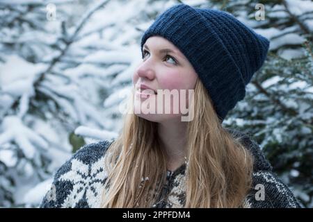 Close-up of a happy teenage girl daydreaming in winter, Bavaria, Germany Stock Photo
