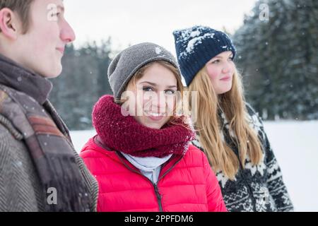 Friends standing in snowy landscape in winter, Bavaria, Germany Stock Photo