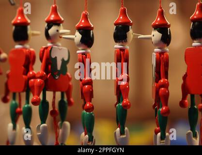 Traditional wooden Pinocchio toy sold in souvenir shop in Cracow. Stock Photo