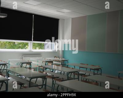 Lecture room with empty seats. Business seminar education. Modern new school. White furniture. Large windows with blackout curtains or blinds. Empty school classroom. Furniture and school equipment Stock Photo